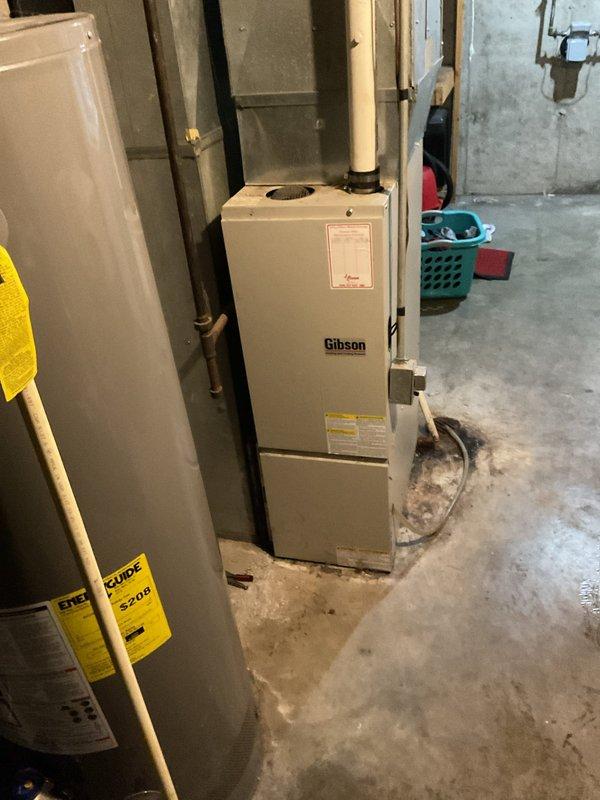 Responded to a no heat service call where customer reported system blowing 63° air while thermostat was set to 74°. Diagnostic testing revealed multiple issues: depleted thermostat batteries, significantly clogged condensate trap, and nearly blocked pressure switch port. System inspection found excessive heat rise at 64° and carbon monoxide level at 28 ppm. Performed comprehensive cleaning and system check to restore proper operation and ensure safe functioning of the Gibson furnace.