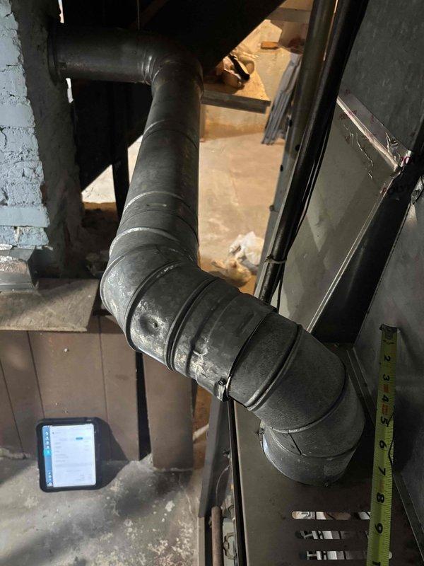 Responded to customer complaint of loud humming noise from furnace. Inspected ductwork and mechanical components, focusing on the elbow joint and connecting sections. Detected vibration in the metal ducting causing the reported noise. Secured loose connections and reinforced ductwork joints to eliminate noise issue. System now operating normally with no unusual sounds.