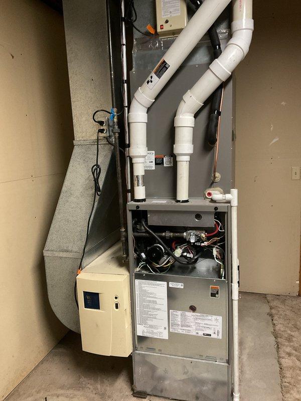 Completed scheduled annual furnace cleaning and maintenance service on high-efficiency furnace system with connected humidifier. Inspected heat exchanger, cleaned burners, tested ignition system, and verified proper venting through PVC exhaust configuration. Customer also reported fireplace ignition issue; diagnosed faulty switch and replaced component to restore proper operation.