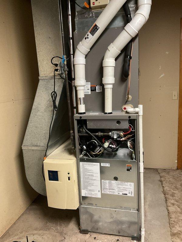 Completed scheduled annual furnace cleaning and maintenance service on high-efficiency furnace system with connected humidifier. Inspected heat exchanger, cleaned burners, tested ignition system, and verified proper venting through PVC exhaust configuration. Customer also reported fireplace ignition issue; diagnosed faulty switch and replaced component to restore proper operation.