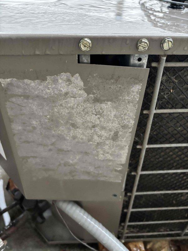 Responded to emergency service call for customer with newborn reporting furnace not heating, making noise with blinking red light (unit operating at 65°F despite 69°F setting). Discovered tripped circuit breaker at panel (circuit #20) and restored power. Found significant ice buildup on evaporator coil/heat exchange system causing restricted airflow. Reset system, thawed ice formation, and verified proper operation to restore heat to residence.