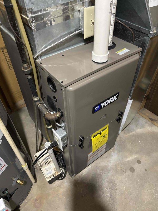 Responded to customer complaint of noise from furnace and smoke odor from bathroom vent. Performed thorough inspection of York furnace system including temperature readings with infrared thermometers. No abnormal operation detected during diagnostic testing and could not replicate reported issues during service visit.