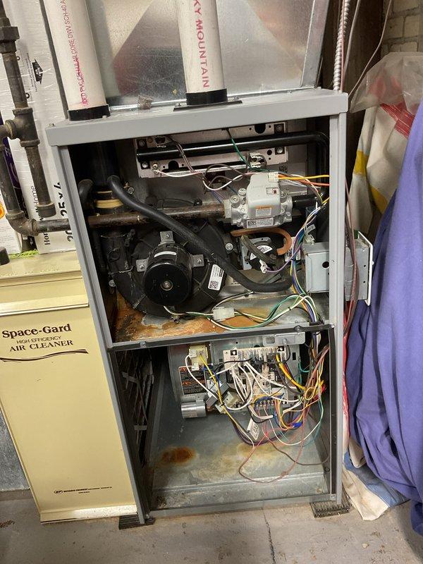 Performed diagnostic testing and tune-up service on 2013 Airflow York Mountain furnace that was not heating properly. Conducted comprehensive system measurements with CRT meter showing temperature readings (T2: 99.6F) and efficiency values (4.4%, 13.2%). Inspected interior components including motor assembly and wiring harnesses, cleaned system, replaced thermostat batteries, and restored proper operation.