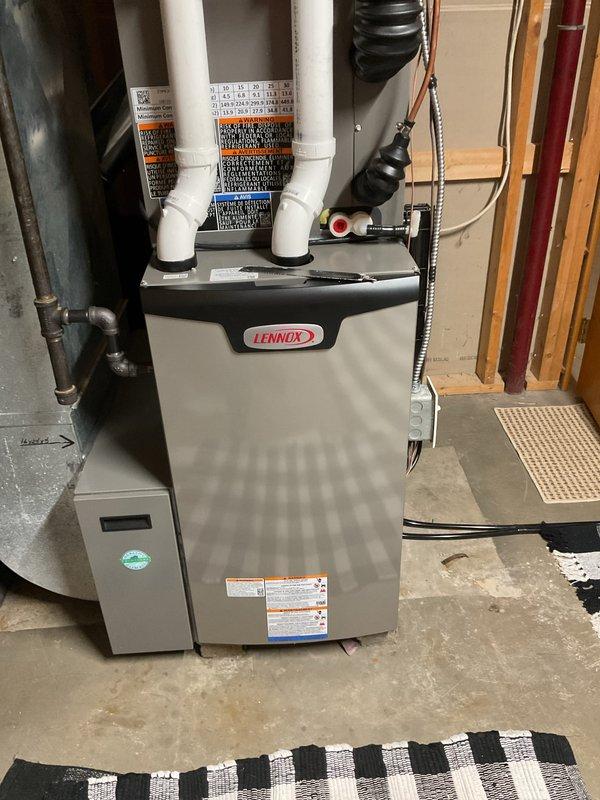Responded to customer complaint of water leakage from furnace. Inspection of Lennox unit revealed exhaust pipe connection was not properly glued, causing exhaust gases to leak onto furnace. Repaired by properly applying adhesive to the PVC joint and verified proper system operation after repair.