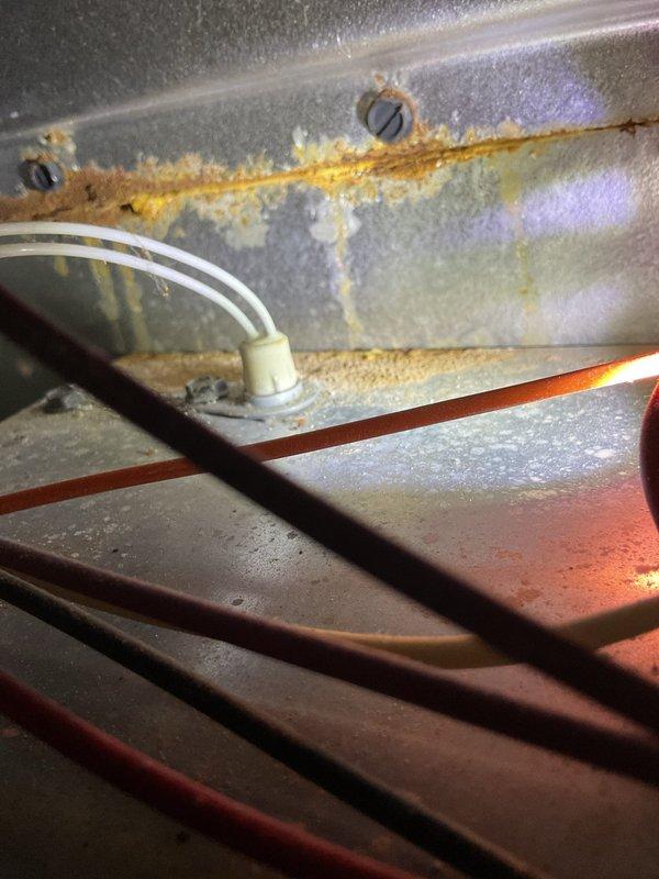 Responded to customer complaint of heating system failure (thermostat set to 71°F with actual temperature at 61°F). Diagnosed issue with flame ignition despite pilot light being on. Performed maintenance on flame sensor and cleaned sensor ports which were showing significant corrosion and rust buildup as documented in photos. System successfully restored to normal operation with proper heating function verified before departure.