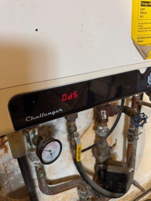 Responded to service call for leaking valve on Challenger boiler system. Upon inspection, found water accumulation near the unit's base connection points. Replaced faulty valve and checked operation of the integrated tankless water heater system with three units and expansion tanks. System now operating within normal parameters with no leaks observed.