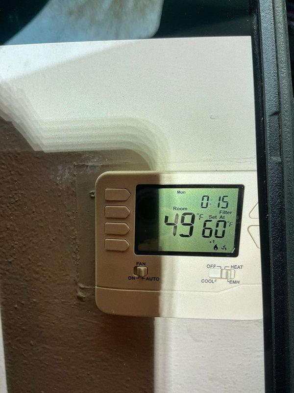 Responded to no-heat call for 30-year-old furnace system. Diagnostic testing revealed blown breaker and excessive amperage draw (394 AC) on blower motor. Thermostat functioning but system unable to maintain temperature (49°F actual vs 60°F setpoint). Determined blower motor failure; recommended system replacement rather than repair due to unit age and component failure.
