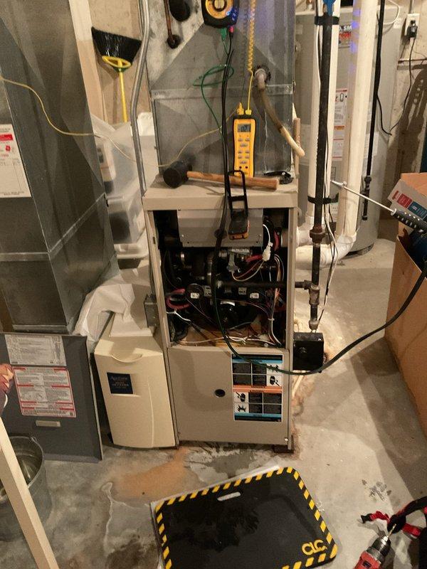 Diagnosed 20-year-old Lennox furnace with no heat issue caused by plugged drain and water accumulation in the inducer motor venturi. Cleared drainage system, cleaned trap, replaced furnace filter, and verified continuous operation after servicing to ensure proper system function.