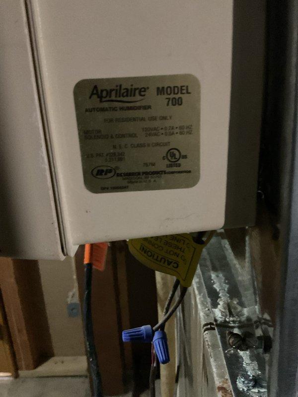 Successfully reinstalled customer's existing Aprilaire Model 700 automatic humidifier that was previously hanging by the water line. Mounted unit securely to the furnace ductwork, reconnected electrical components using proper wire connections, and verified system operation.