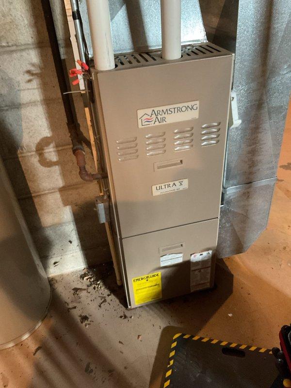 Responded to no-heat call for residence with Armstrong Air Ultra V furnace. Upon arrival, system was operating but producing insufficient heat. Diagnostic testing revealed critically low battery levels in Nest thermostat affecting proper communication with furnace. Replaced batteries and performed standard clean and check procedure. System now operating at proper specifications with adequate heat output.