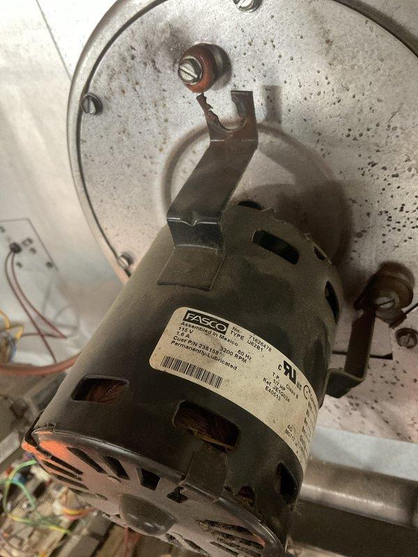 Responded to service call for unit heater not working in mechanic shop. Inspected Fasco blower motor assembly which showed signs of failure. Motor was found mounted on circular plate within HVAC equipment housing with visible dust accumulation and wear. Service restored heating functionality to the unit.