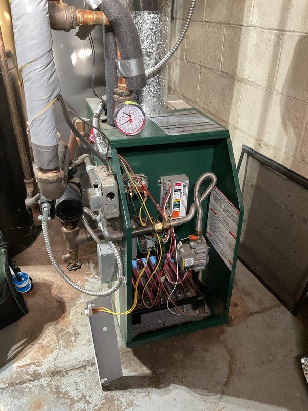 Responded to no heat call for customer with green boiler unit. Performed diagnostic inspection of heating system, checking wiring connections, pressure gauge readings, and examining the hydronic distribution piping. Found issue and restored heat functionality to proper operation.