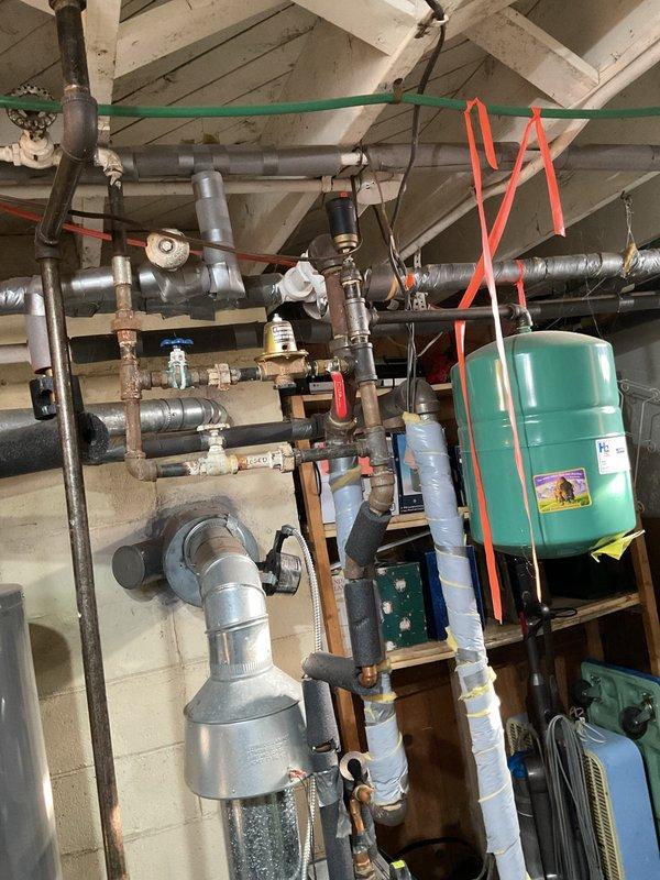 Responded to no heat call for customer with green boiler unit. Performed diagnostic inspection of heating system, checking wiring connections, pressure gauge readings, and examining the hydronic distribution piping. Found issue and restored heat functionality to proper operation.