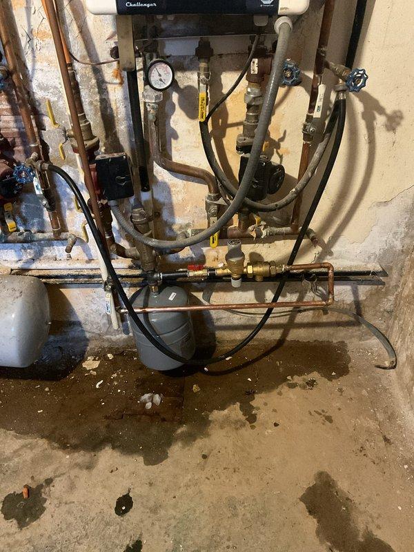 Responded to service call regarding system water pressure issues. Replaced deteriorated autofill valve, backflow preventer, and expansion tank on Challenger boiler system that showed signs of leakage. Verified proper operation of new components with system pressure stabilized at 6 PSI.