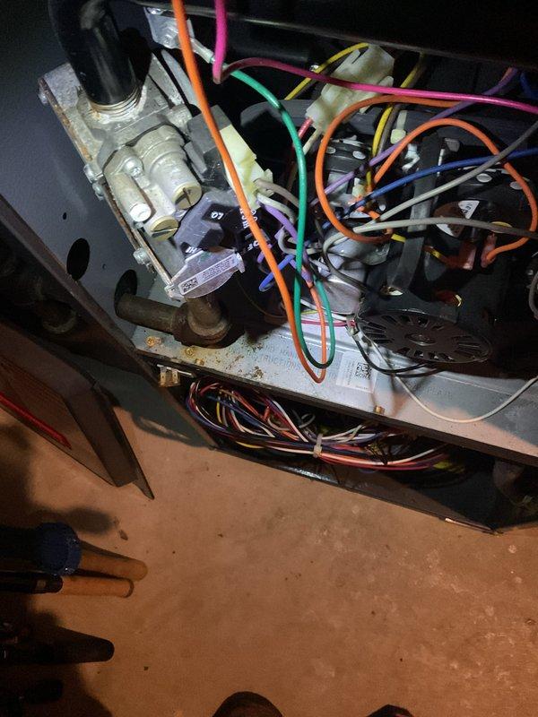 Responded to no heat call and diagnosed a faulty gas valve in Goodman furnace. Removed access panel to inspect internal components and wiring, then replaced defective gas valve to restore proper heating operation.