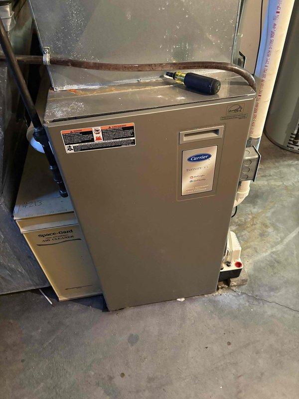 Diagnosed and replaced faulty pressure switch on aging Carrier Infinity furnace that was experiencing no-heat condition. Visual inspection revealed corrosion at wiring connections, indicating moisture exposure and component deterioration consistent with system age. Installation of new pressure switch restored proper system operation and heating functionality.