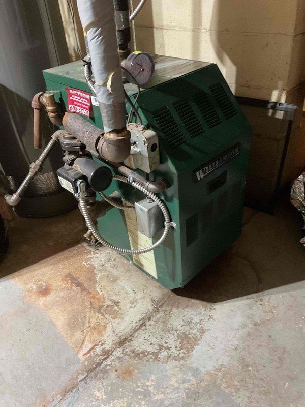 Responded to callback for Weil-McLain boiler heating system that had failed after previous day's service. Discovered loose pilot assembly connection to gas valve, which was tightened securely. System was tested approximately 10 times with successful ignition on each attempt, confirming immediate main burner engagement. Customer was advised that if issues persist, replacement of the pilot assembly with new sensor and wiring would be recommended.