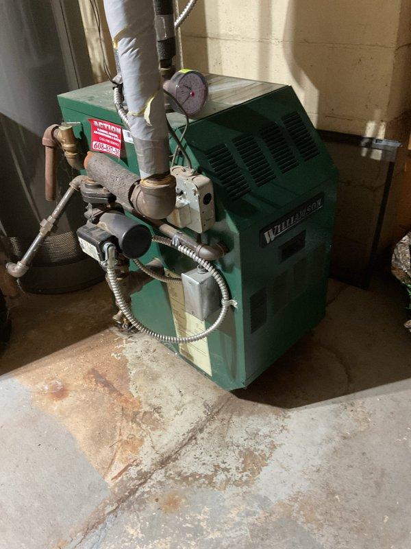 Responded to callback for Weil-McLain boiler heating system that had failed after previous day's service. Discovered loose pilot assembly connection to gas valve, which was tightened securely. System was tested approximately 10 times with successful ignition on each attempt, confirming immediate main burner engagement. Customer was advised that if issues persist, replacement of the pilot assembly with new sensor and wiring would be recommended.