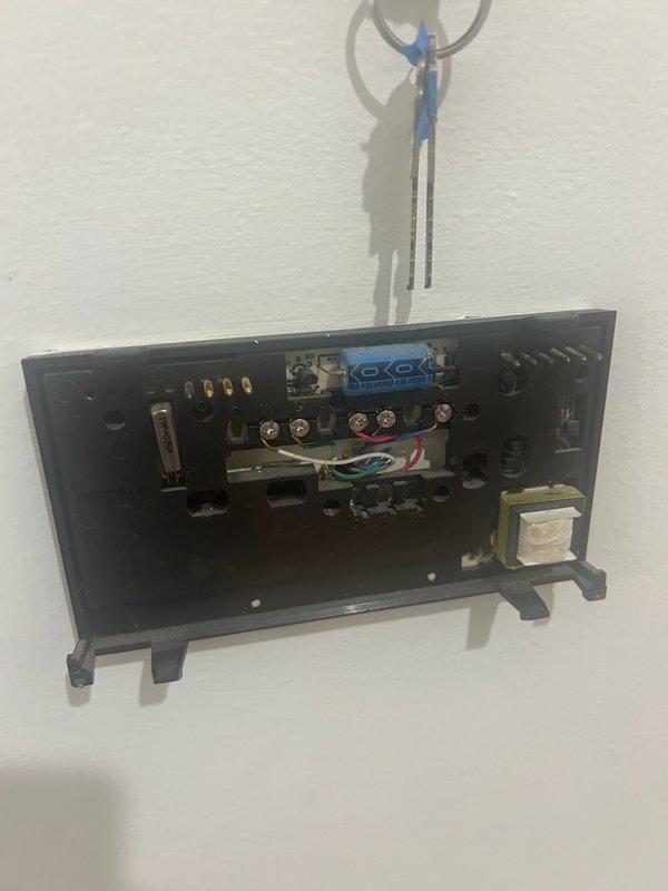 Completed thermostat replacement service, removing outdated unit and installing new Honeywell Home digital programmable thermostat. Connected and tested all wiring (green, red, white) to ensure proper functionality, with system now operating correctly showing 68° current temperature with 50° set point in HOME mode.