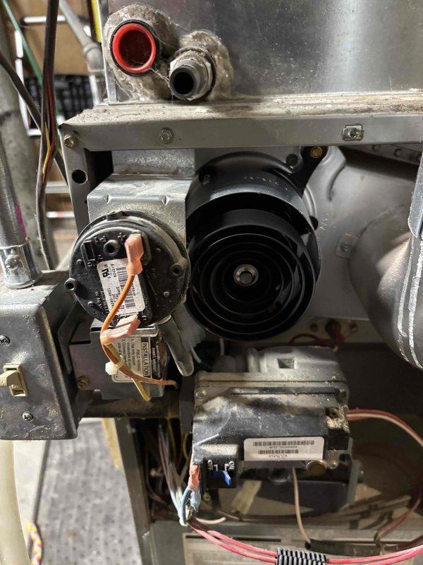 Replaced failed inducer motor on Carrier furnace. Removed old assembly, installed new inducer motor and verified proper operation. System now functioning correctly with normal combustion and airflow.