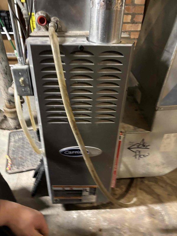 Replaced failed inducer motor on Carrier furnace. Removed old assembly, installed new inducer motor and verified proper operation. System now functioning correctly with normal combustion and airflow.