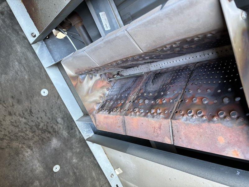 Responded to service call for furnace in rear shop not producing heat. Diagnosed issue with gas control module and performed system reset to restore proper operation. Observed significant rust and corrosion on heat exchanger panels during inspection.