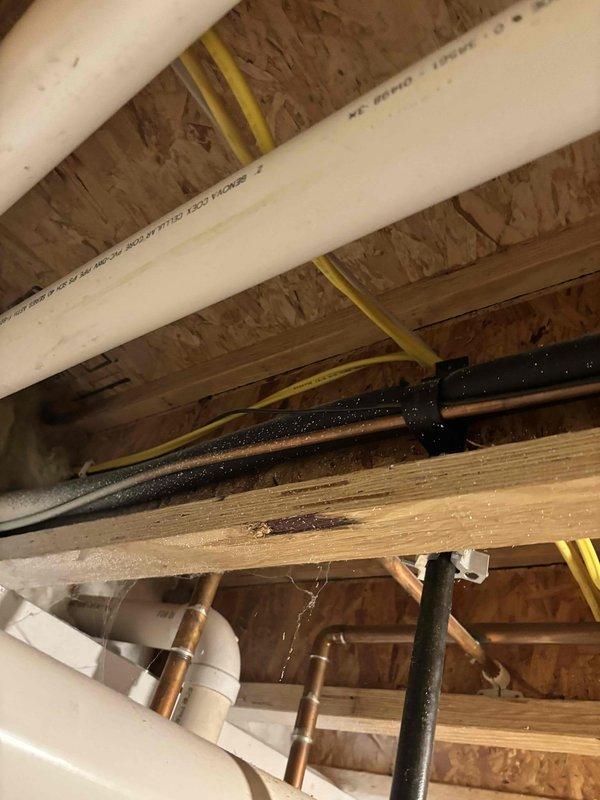 Conducted site assessment for potential A/C unit relocation. Evaluated current installation in unfinished basement/utility area, documenting existing infrastructure including electrical panel connections, plumbing interfaces, and structural considerations. Photos taken of exposed joists, conduits, and utility connections to develop comprehensive relocation estimate.