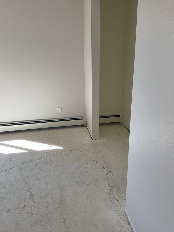 Completed installation of new baseboard heating units and wall-mounted air conditioning system in a fire-damaged unit. Properly mounted AC unit with white trim to the weather barrier wall surface and ensured proper connection. Verified system functionality before completing the job.