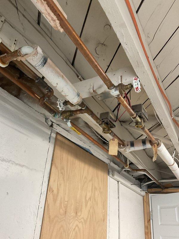 Completed removal of existing baseboard heating system in basement as requested. Inspected and documented the condition of the copper and PVC piping infrastructure, noting minor corrosion on some copper components. Capped off supply lines at ceiling junction points to properly decommission the system while maintaining integrity of the remaining plumbing network.