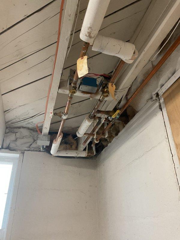 Completed removal of existing baseboard heating system in basement as requested. Inspected and documented the condition of the copper and PVC piping infrastructure, noting minor corrosion on some copper components. Capped off supply lines at ceiling junction points to properly decommission the system while maintaining integrity of the remaining plumbing network.