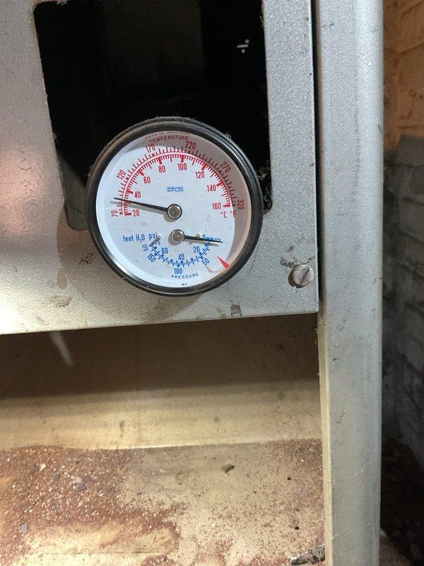 Responded to no heat call for steam radiator system. Diagnosed empty boiler as the root cause. Refilled boiler and discovered faulty pressure gauge, which was confirmed when the pressure relief valve activated prematurely before system reached normal operating temperature.
