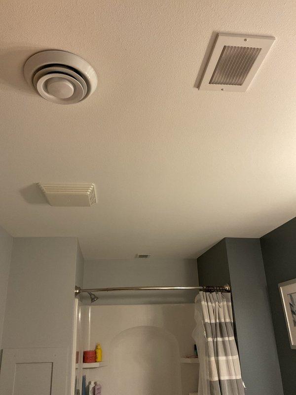 Responded to heating issue in basement zone. Inspected bathroom ventilation system including ceiling exhaust fan and multiple air vents. Examined furnace and ductwork system in utility closet, noting proper PVC exhaust configuration. Resolved problem by opening closed diffusers to restore proper airflow and heat distribution to basement.