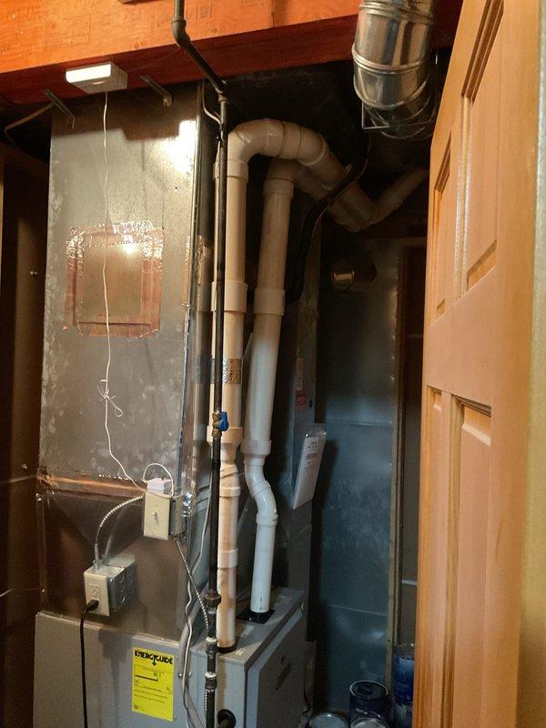 Responded to heating issue in basement zone. Inspected bathroom ventilation system including ceiling exhaust fan and multiple air vents. Examined furnace and ductwork system in utility closet, noting proper PVC exhaust configuration. Resolved problem by opening closed diffusers to restore proper airflow and heat distribution to basement.