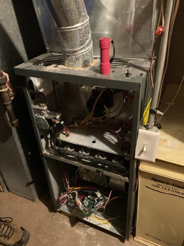 Diagnosed and replaced faulty control board in older Goodman furnace that was not producing heat. Inspected internal components including blower motor and wiring connections. System is now operational and heating properly.
