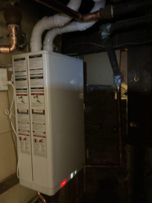 Responded to warranty service call regarding no heat on second floor. Diagnosed air trapped in system and performed bleeding procedure on multiple radiators to restore proper heat circulation. Documented existing boiler system with photographs showing furnace unit with PVC venting and associated plumbing connections.