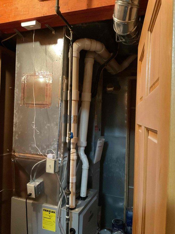 Responded to warranty service call regarding no heat on second floor. Diagnosed air trapped in system and performed bleeding procedure on multiple radiators to restore proper heat circulation. Documented existing boiler system with photographs showing furnace unit with PVC venting and associated plumbing connections.