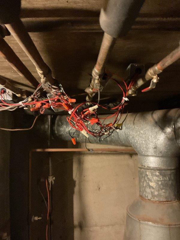 Replaced defective zone valve pop top in boiler heating system, requiring complete removal and installation of new component. Electrical connections were rewired to ensure proper functionality. Customer was advised of existing leaks in the system that may require future attention.