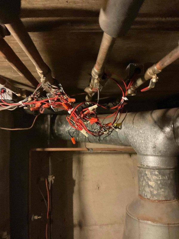Replaced defective zone valve pop top in boiler heating system, requiring complete removal and installation of new component. Electrical connections were rewired to ensure proper functionality. Customer was advised of existing leaks in the system that may require future attention.