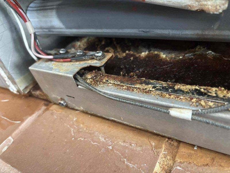 Responded to service call for furnace displaying PF trouble code with no heat. Diagnosed issues with flame sensor and leaking drain tube. Performed thorough cleaning of flame sensor to restore proper operation and ordered replacement drain tube to address condensate leak. Inspection revealed significant corrosion on internal components and dust accumulation on wiring system requiring attention.