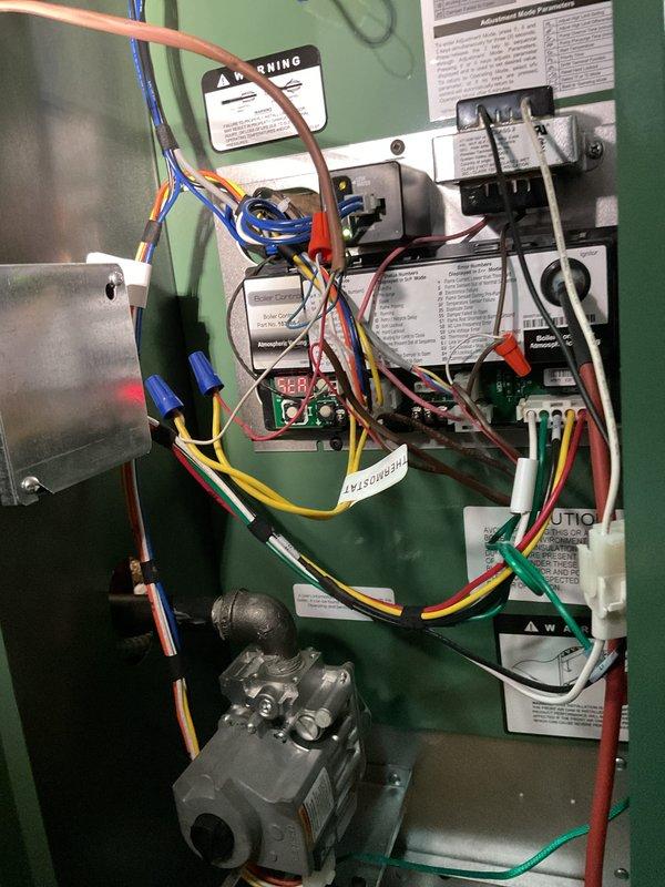 # Service Report

Responded to service call for boiler not operating following installation completed previous week. Upon arrival, accessed control panel and performed comprehensive diagnostic of electrical system and safety controls. Identified wiring connection issues affecting proper system operation. Verified and corrected all wire terminations at control board, transformer, relay, and gas valve connections. Ensured proper wire routing and secure connections throughout control panel using appropriate wire nuts. Tested all safety interlocks and limit controls for proper operation. Verified gas valve functionality and control signal integrity. Cycled system through multiple heating cycles to confirm reliable ignition sequence and burner operation. All components now functioning within manufacturer specifications. System operational and customer informed of proper operation procedures.