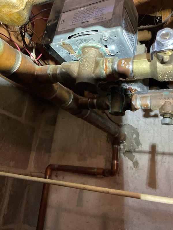 Responded to building overheating issue caused by malfunctioning zone valve control on baseboard heating system. Diagnosed miswired thermostat connections causing zone valve actuator to continuously rotate, preventing proper temperature regulation throughout the building. Disconnected faulty zone valve and two thermostats from the system to restore proper heating control and eliminate overheating condition.
