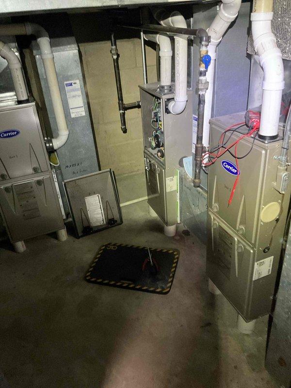 Responded to no-heat call on Carrier furnace system. Replaced thermostat batteries, cleaned condensate trap to remove blockage, and cleaned flame sensor. Verified proper ignition sequence and confirmed unit achieved stable combustion and normal heating operation upon completion.