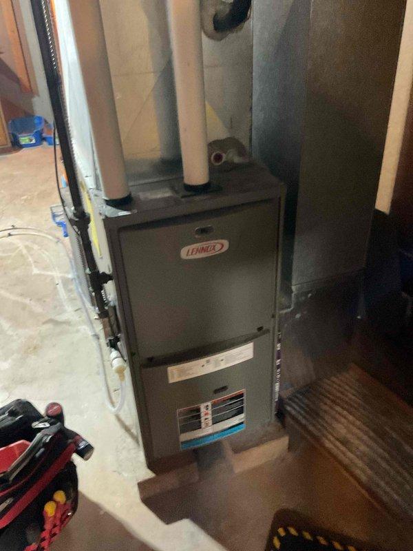 Responded to no heat call on Lennox furnace. Diagnosed failed draft inducer motor preventing proper venting and system operation. Removed old inducer assembly and installed new replacement draft inducer motor. Verified proper operation, confirmed adequate airflow through PVC vent piping, and tested furnace through complete heating cycle. Unit restored to normal operation with proper draft pressure and heat output.