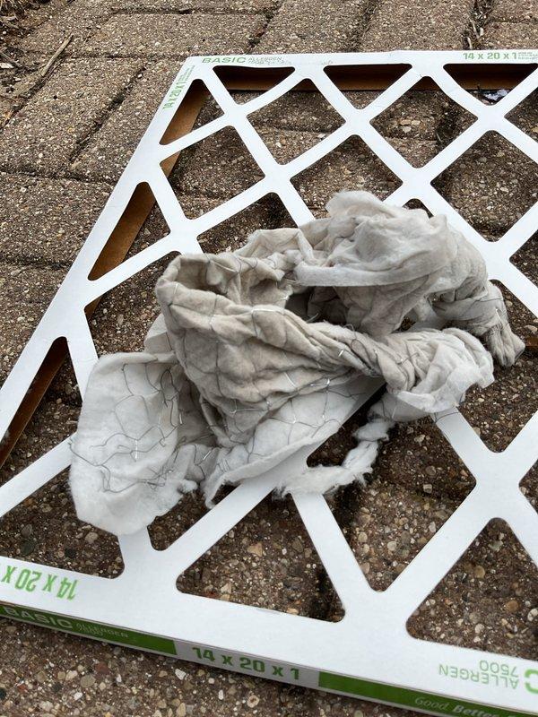 Responded to warranty call for recently installed furnace experiencing severe vibration and shaking. Upon inspection, discovered air filter had collapsed with metal mesh completely missing, having been drawn into the system due to excessive negative pressure. Determined cold air return duct was undersized for the furnace specifications, creating insufficient airflow and causing the filter failure. Removed damaged filter debris from system, took measurements of existing cold air return for proper resizing and fabrication to prevent recurrence of the issue.