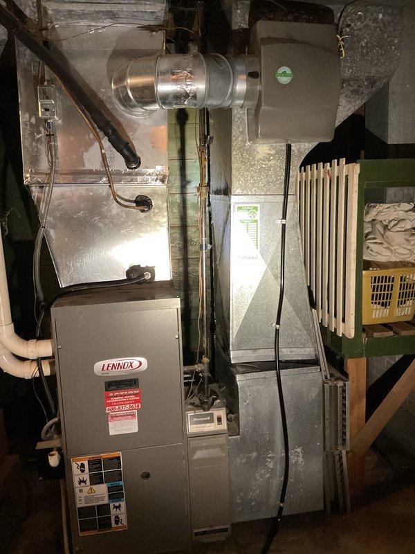 Responded to service call for water accumulation under furnace. Upon inspection, identified moisture issue in basement mechanical room near Lennox furnace and air handler system. Replaced air filter with homeowner-supplied #35 X2661 filter per manufacturer specifications. Documented HVAC system installation including blower unit, ductwork, and associated components in attic crawl space and basement locations. Verified system operation and confirmed no active leaks present at time of service completion.