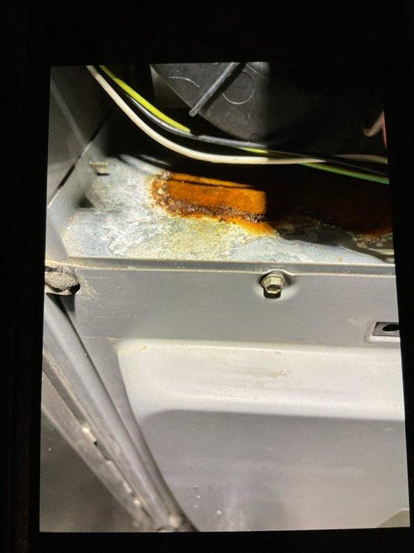Completed prepaid heating maintenance visit. Found plugged condensate drain line and cleared blockage to restore proper drainage. Performed comprehensive clean and check of system components. Documented equipment condition including rust staining on interior panel indicating previous moisture exposure, now resolved with drain line cleaning.