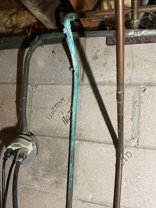 Completed routine maintenance on 12-year-old furnace and air conditioning system, performing cleaning and verification that all components are operating to factory specifications. Inspected corroded turquoise water pipe in basement utility area showing significant deterioration and paint flaking, documented condition with photographs for estimate preparation. System cleanup performed upon completion.