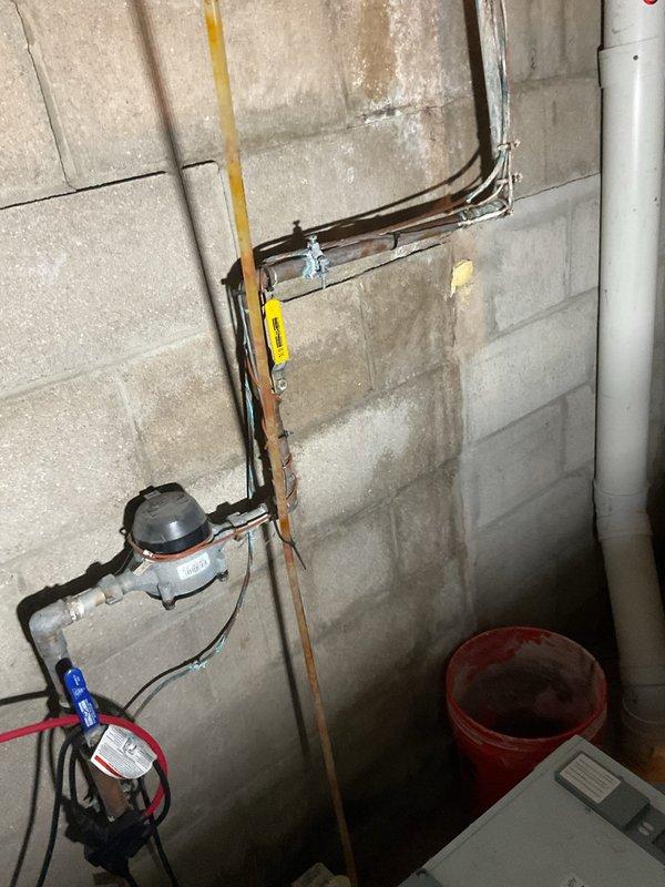 Completed routine maintenance on 12-year-old furnace and air conditioning system, performing cleaning and verification that all components are operating to factory specifications. Inspected corroded turquoise water pipe in basement utility area showing significant deterioration and paint flaking, documented condition with photographs for estimate preparation. System cleanup performed upon completion.