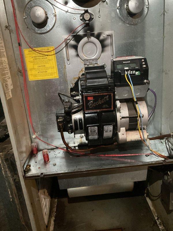 Responded to no-heat call on oil-fired furnace that would not ignite. Diagnosed fuel delivery issue and replaced oil burner nozzle and in-line fuel filter. Performed combustion analysis and adjusted air-to-fuel ratio for optimal efficiency. Verified proper ignition sequence and confirmed unit operating within manufacturer specifications with adequate heat output.