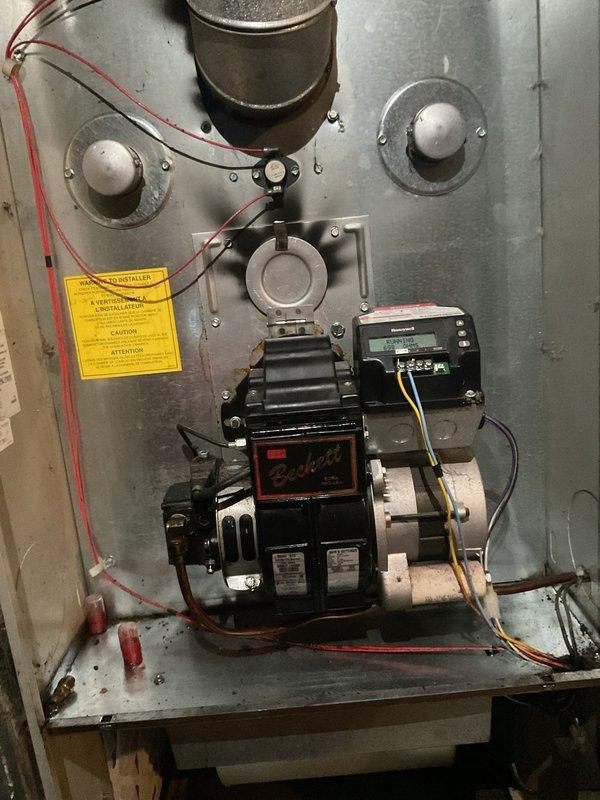 Responded to no-heat call on oil-fired furnace that would not ignite. Diagnosed fuel delivery issue and replaced oil burner nozzle and in-line fuel filter. Performed combustion analysis and adjusted air-to-fuel ratio for optimal efficiency. Verified proper ignition sequence and confirmed unit operating within manufacturer specifications with adequate heat output.